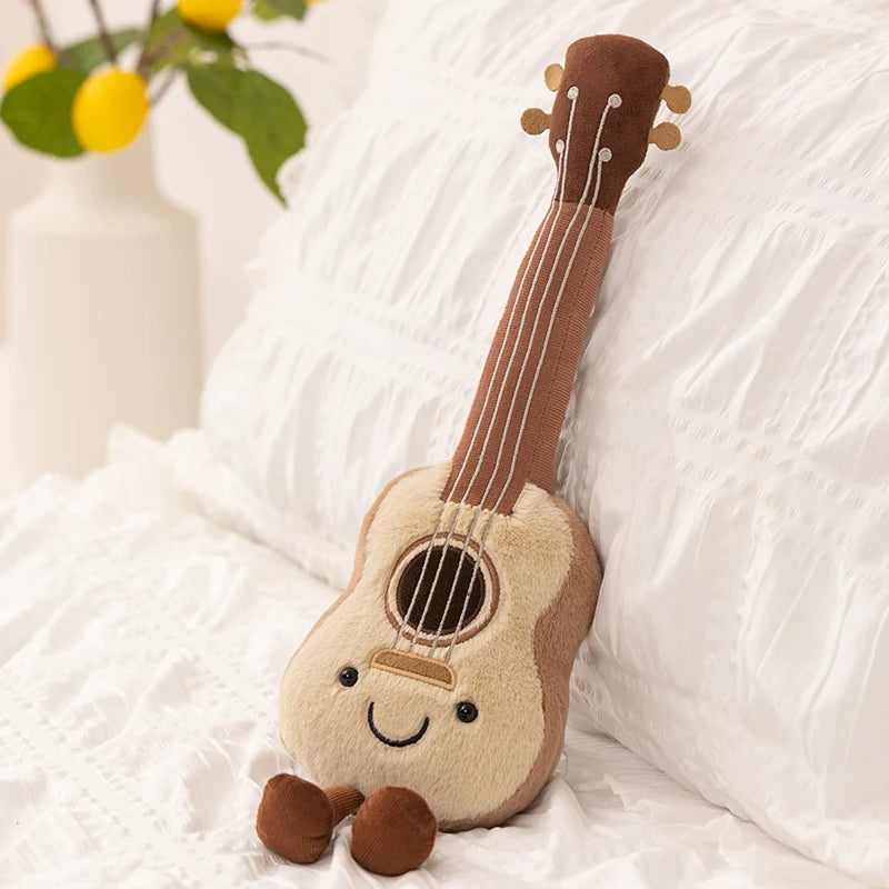 Kawaii plush toy guitar with a smiling face on a white surface