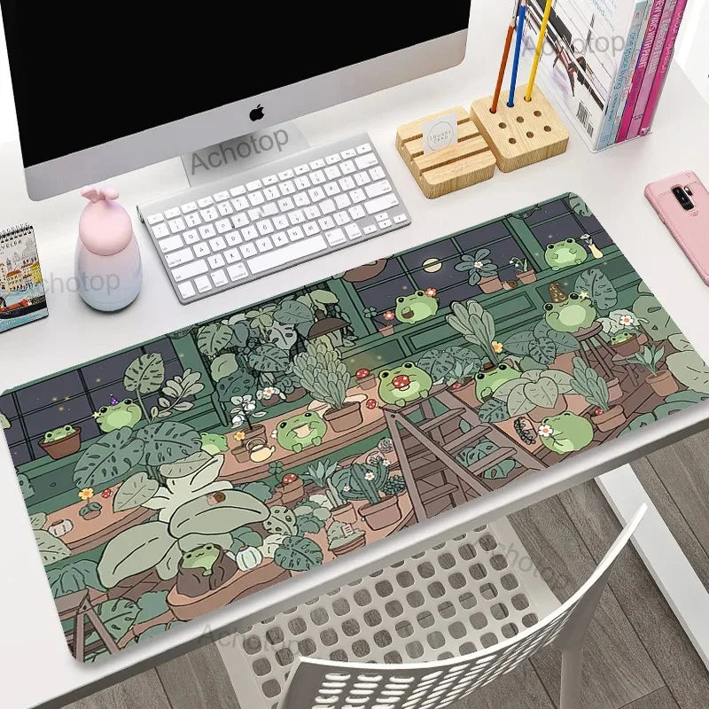 Desk setup with a decorative mouse pad featuring Kawaii frogs and plants.
