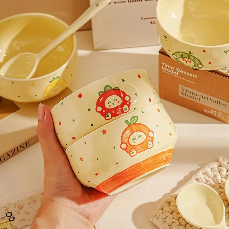 Two cartoon designed kawaii bowls being held