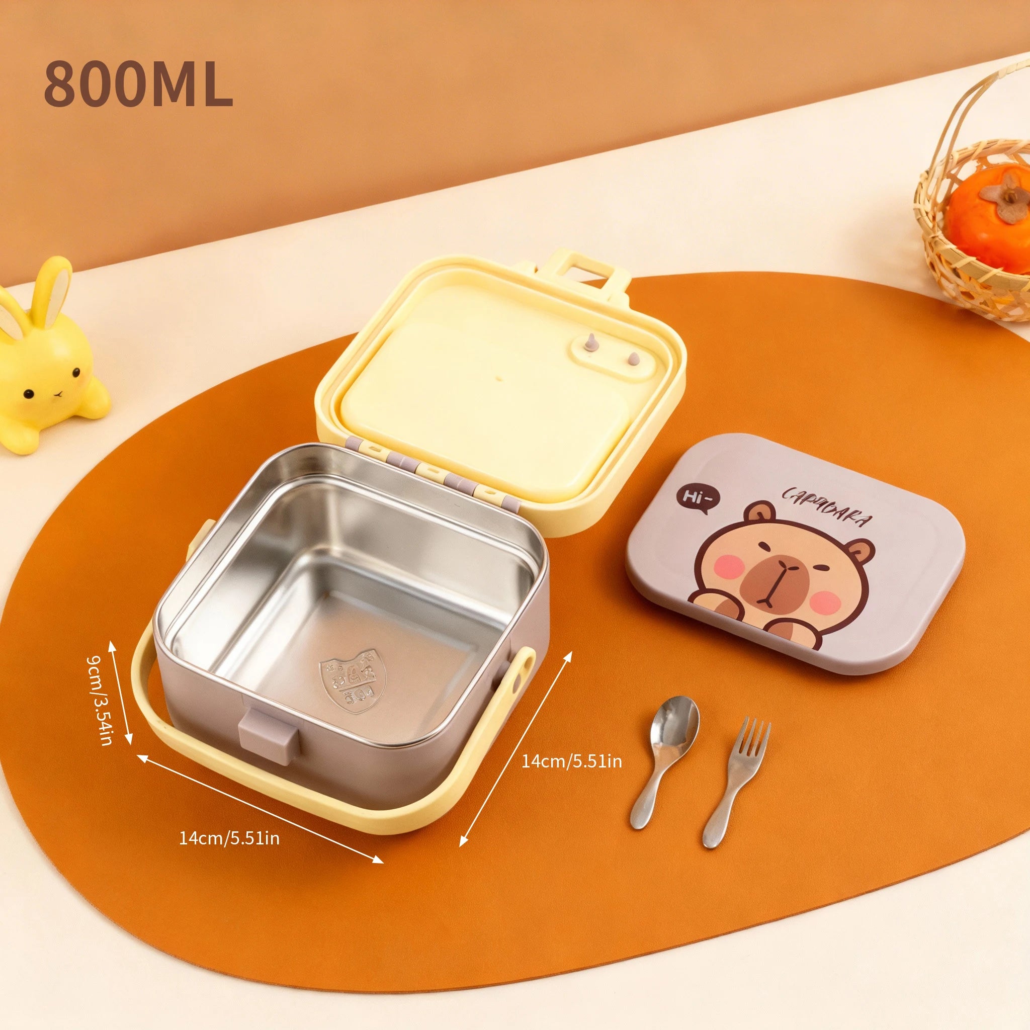 Children's kawaii lunch box set with bear design on an orange surface