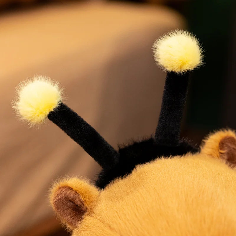 Close-up of a kawaii plush bee toy with yellow fuzzy feelers and black antennae.
