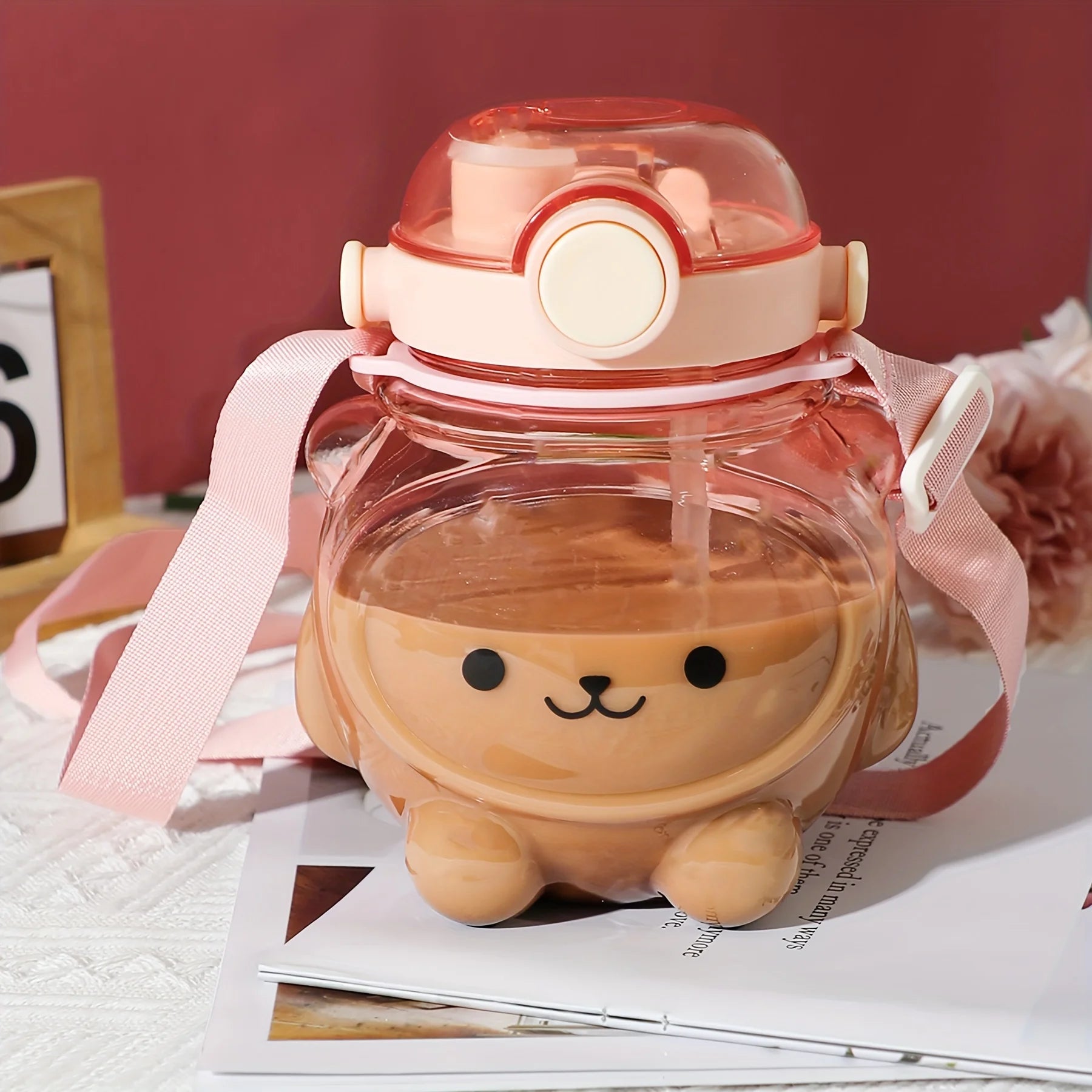 Cute cartoon-style kawaii water bottle with a pink lid on a surface with a pink background
