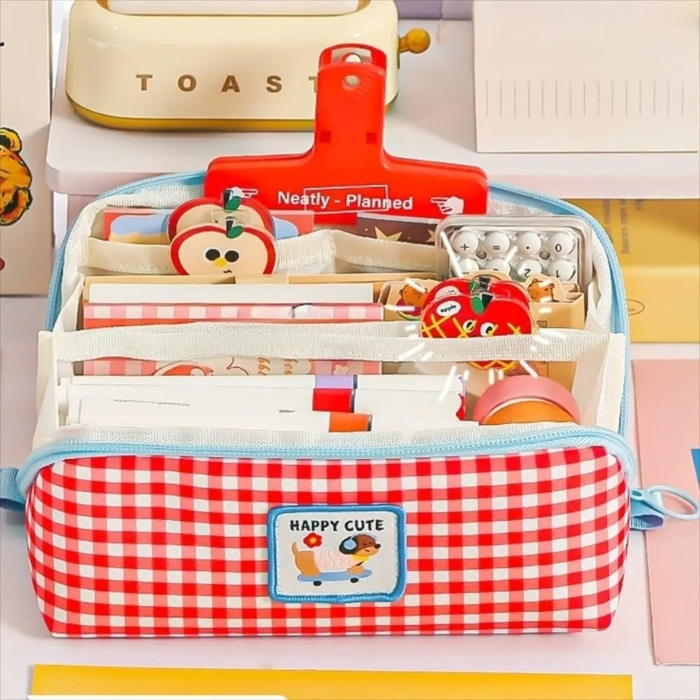 Red and white kawaii checkered pencil case with 'Happy Cute' label, containing stationery items on a light background.