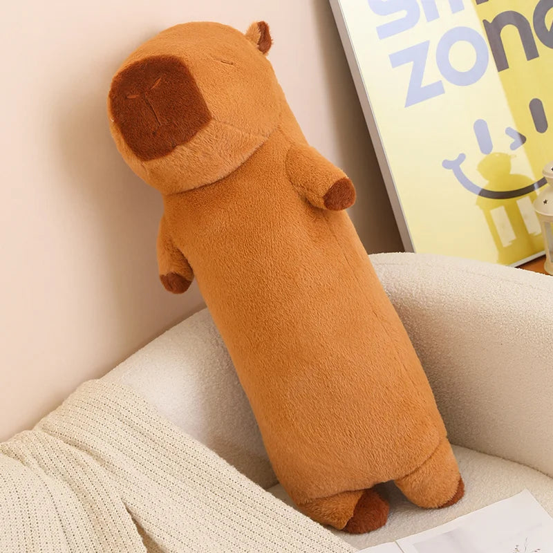 Brown kawaii plush toy resembling a dog on a couch with a blurred background
