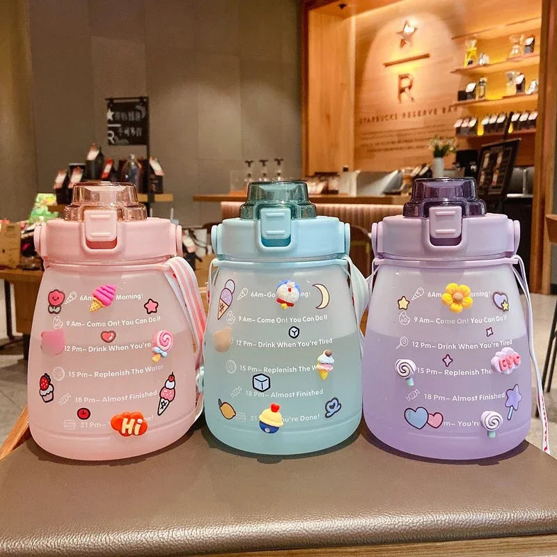 Three colorful kawaii water bottles with decorative elements on a counter.