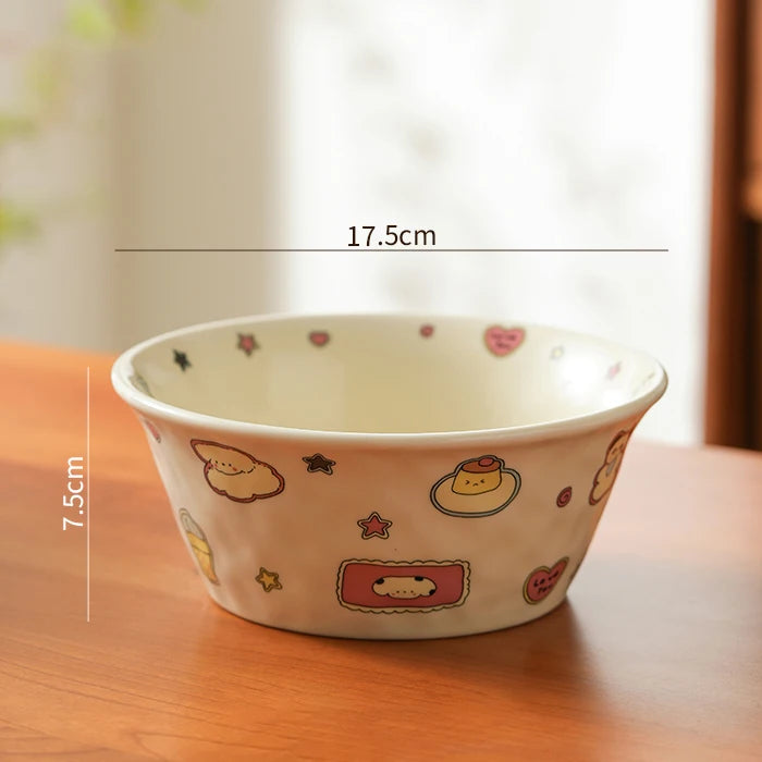 Ceramic kawaii ramen bowl with cartoon designs on a wooden surface, showing measurements.