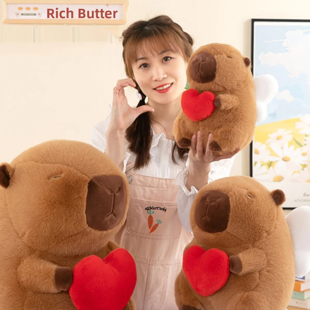 Woman holding a kawaii plush animal with a heart, wearing an apron, in a home setting.