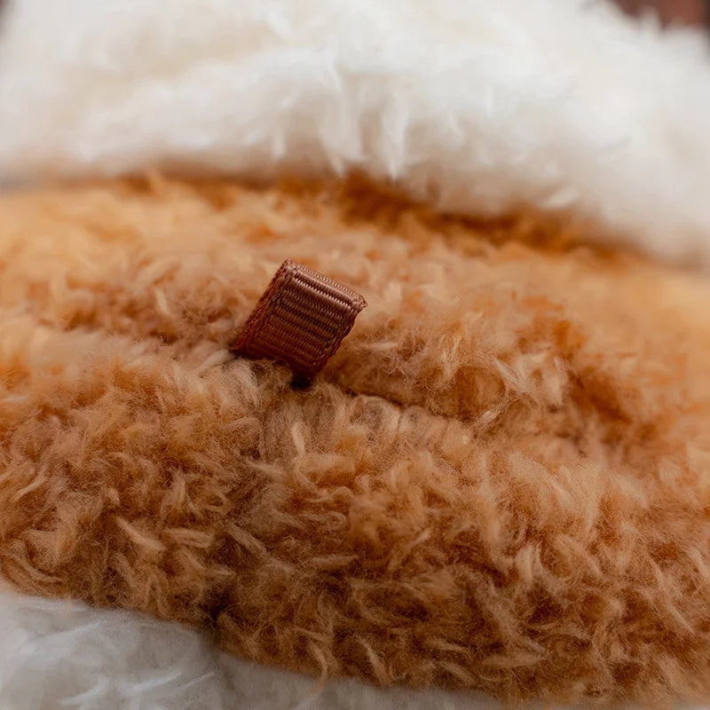 Close-up of a fluffy brown and white kawaii plush toy with a small brown tag.