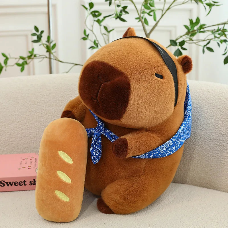 Kawaii plush bear toy with a blue bandana sitting on a couch.