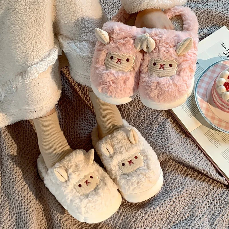 Pair of fluffy slippers with kawaii cartoon face design on a textured surface.
