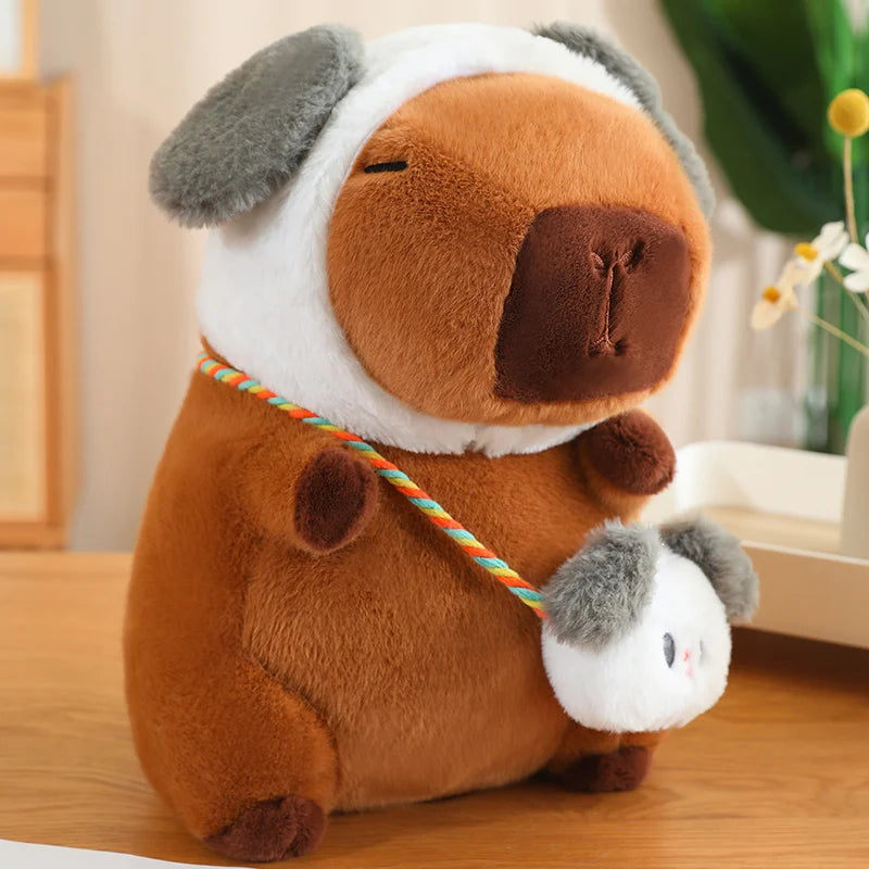 Kawaii plush toy dog with a smaller plush toy on a leash, sitting on a wooden surface.