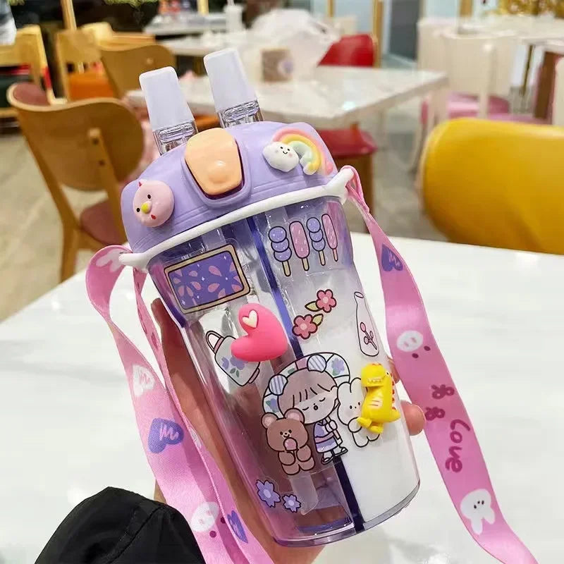 Colorful kawaii water bottle with cartoon designs held by a person in an indoor setting.