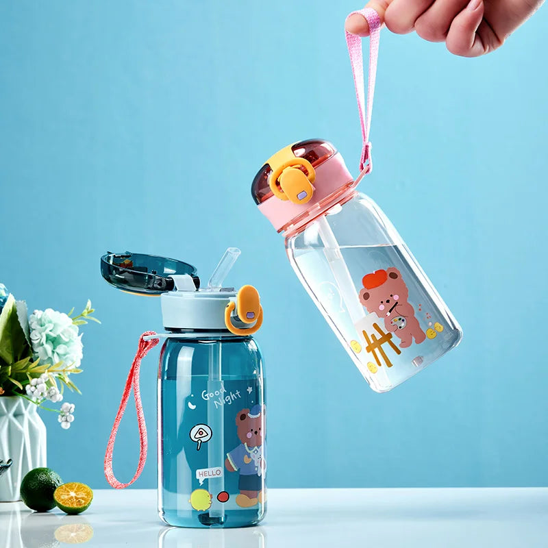 Two children's kawaii water bottles with cartoon designs on a light blue background