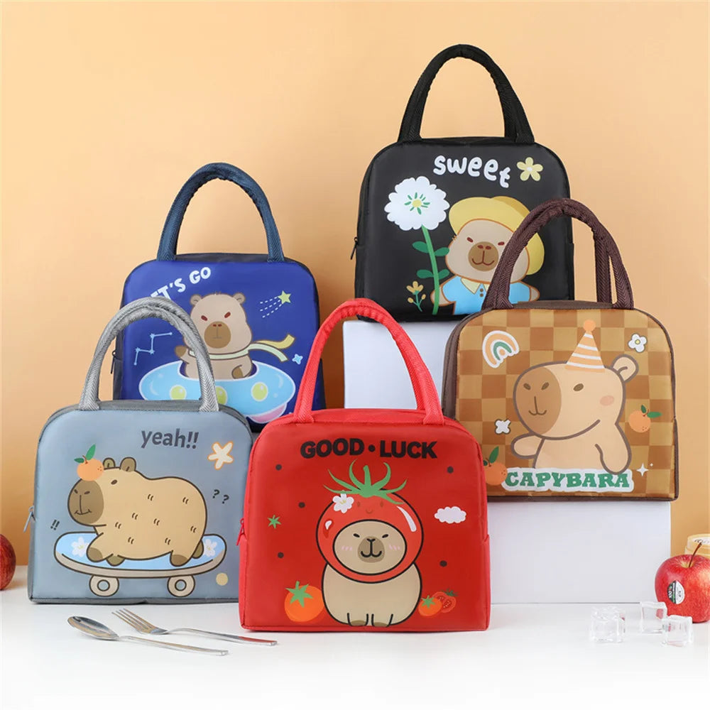 Set of cartoon-themed kawaii lunch bags on a white surface with a beige background