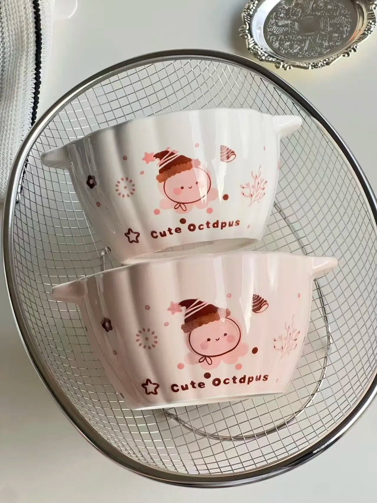 Two kawaii ramen bowls shaped like pumpkins on the kitchen table