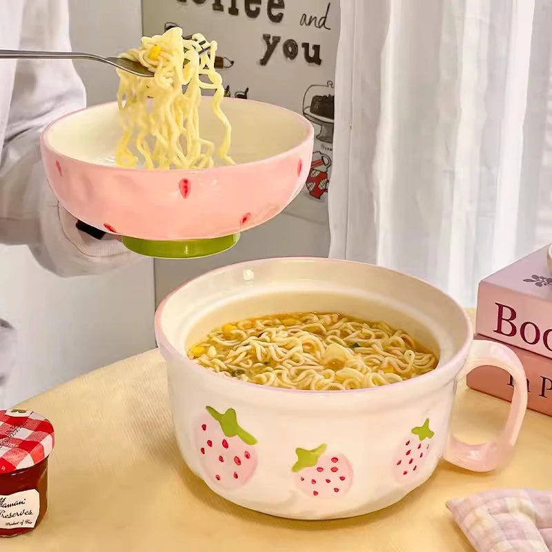 Pink strawberry-themed kawaii bowl with noodles on a table