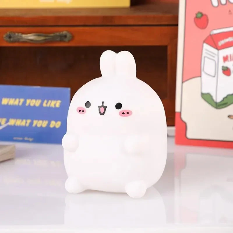 Cute white kawaii plush toy with a smiling face on a reflective surface.