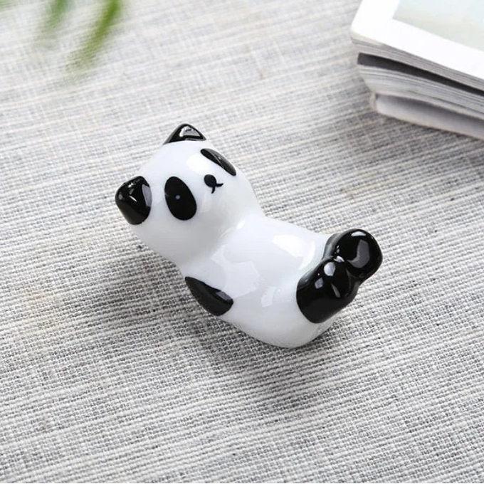 Panda-shaped kawaii chopstick holders on a textured surface with dimensions displayed