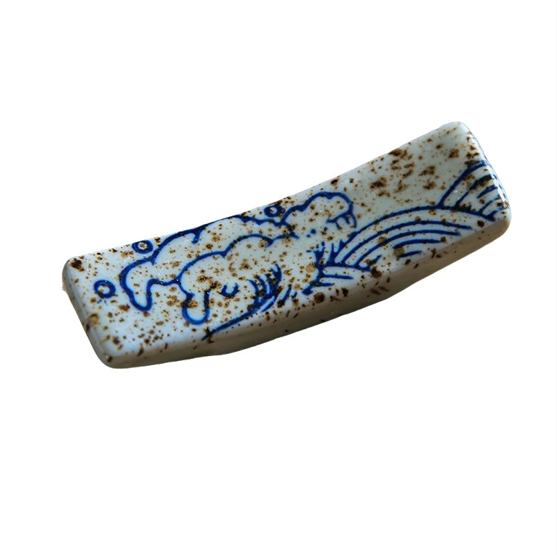 Rectangular ceramic kawaii chopstick holder with blue floral patterns on a white background