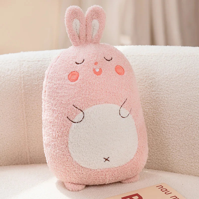 Pink kawaii plush toy with a face on a beige couch