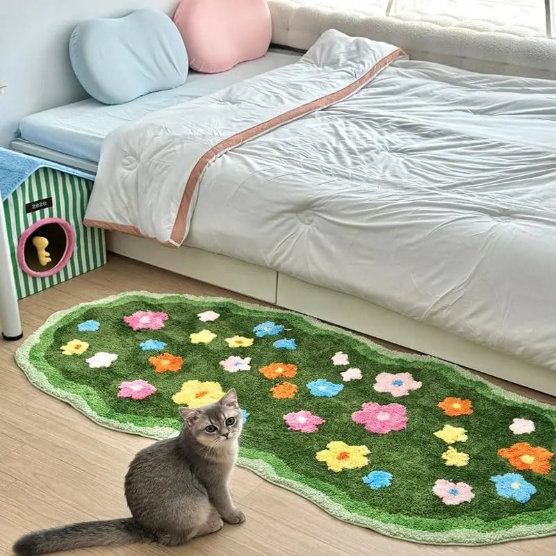 Cat sitting on a floral kawaii rug in front of a bed with colorful pillows.