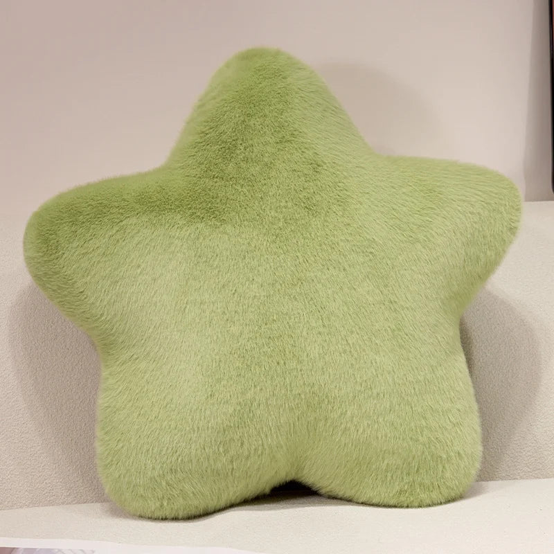 Green star-shaped pillow on a beige sofa