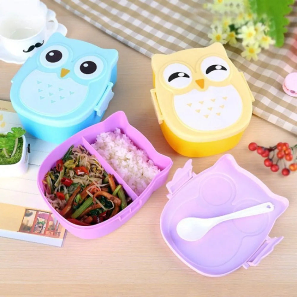 Three owl-shaped lunch kawaii boxes in blue, yellow, and purple with food compartments on a wooden surface.