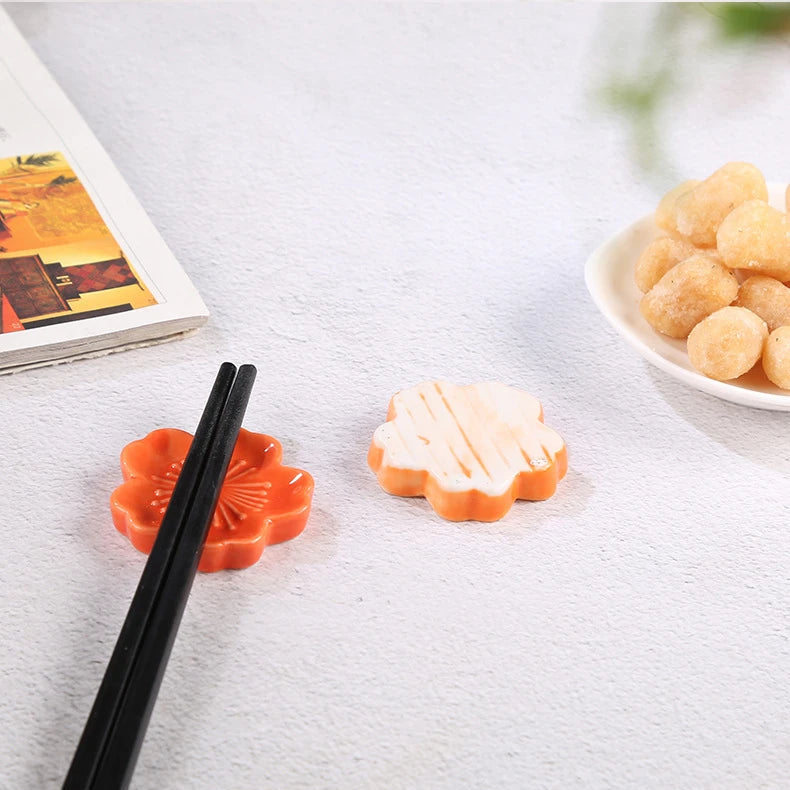 Two kawaii chopstick holder sitting on a table