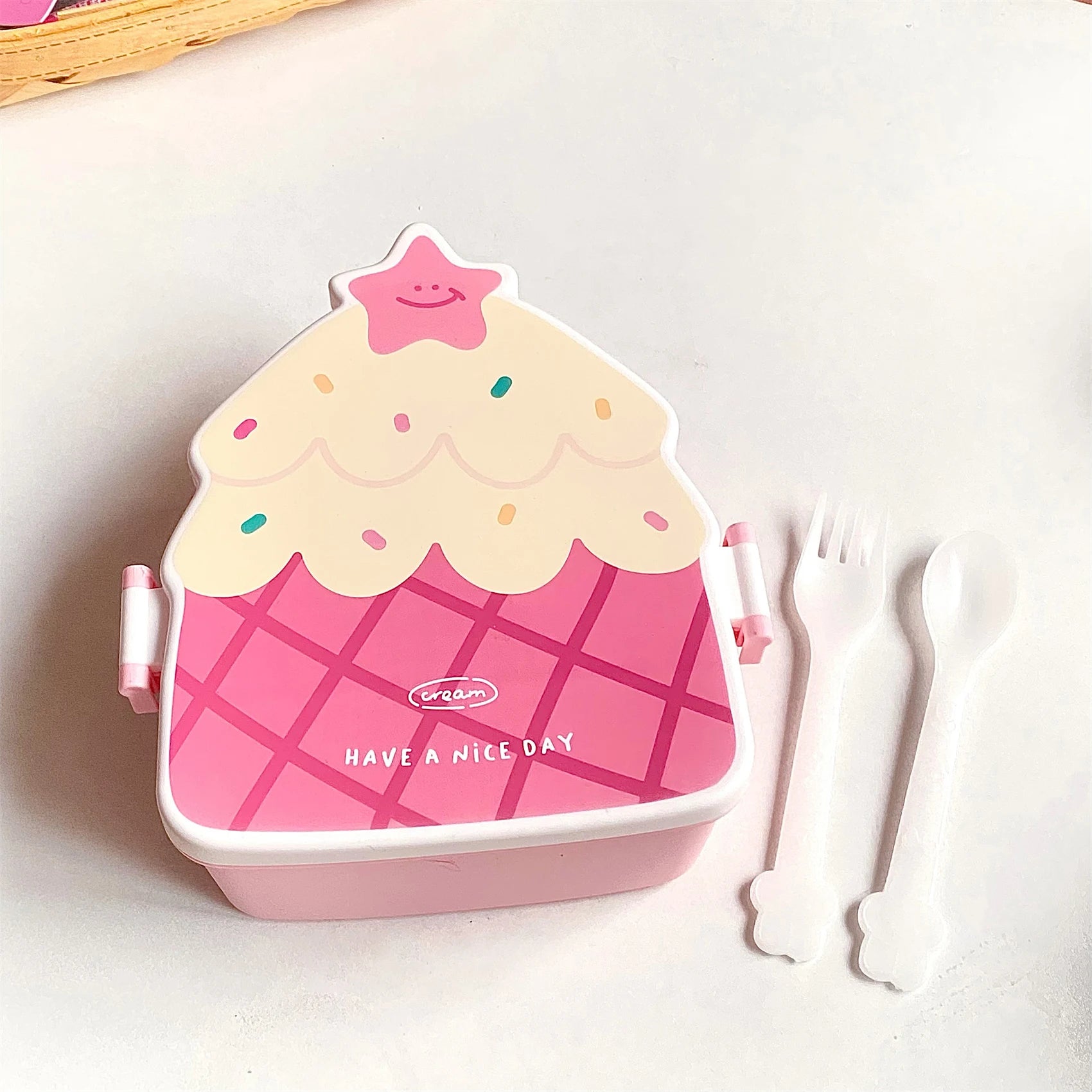 Pink ice cream-themed kawaii lunch box with a smiley face on a white background