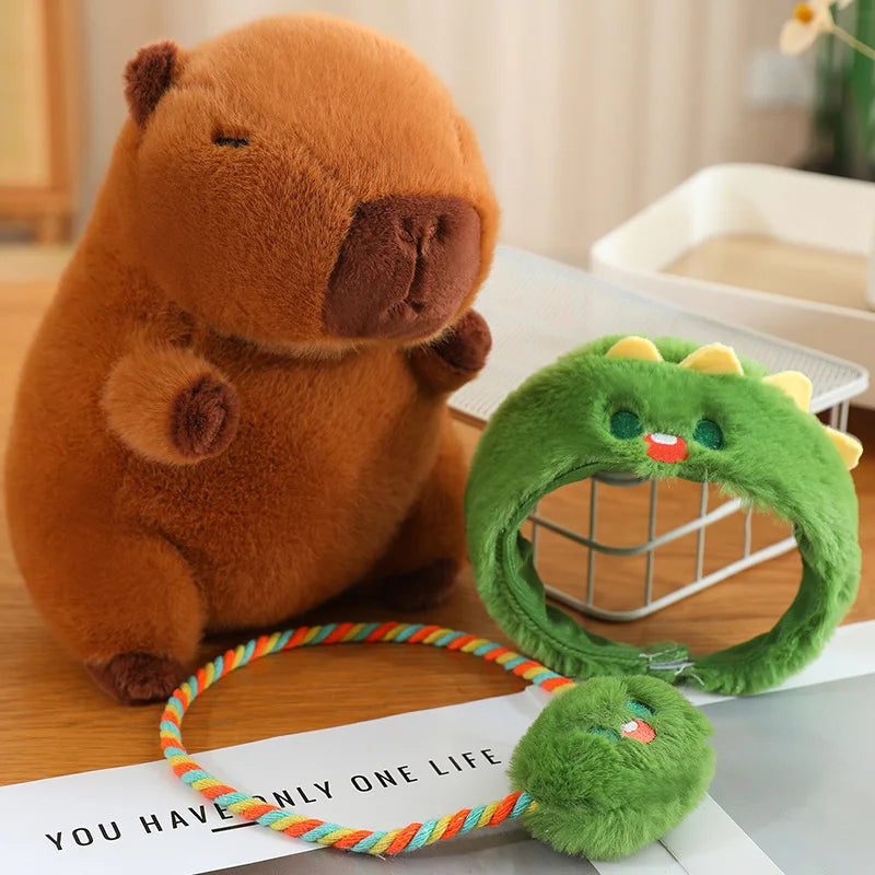 Kawaii plush toy beaver with a green dinosaur-shaped toy on a table.