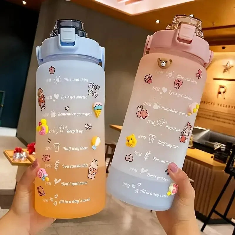 Two colorful kawaii water bottles with motivational text and graphics held in a hand.
