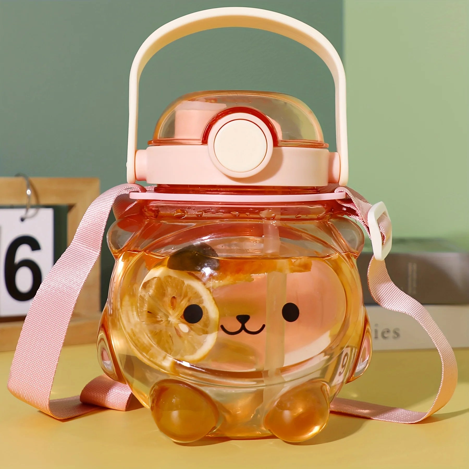 Clear kawaii water bottle with cartoon character design on a yellow surface