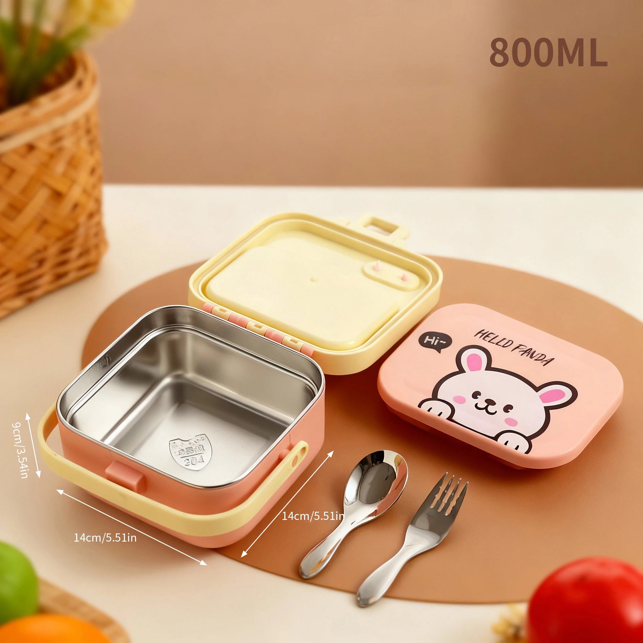 Children's kawaii lunch box set with pink and yellow design, including a bento box, spoon, and fork on a wooden surface.
