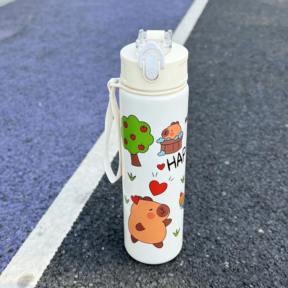 White kawaii water bottle with cartoon designs on a blacktop surface