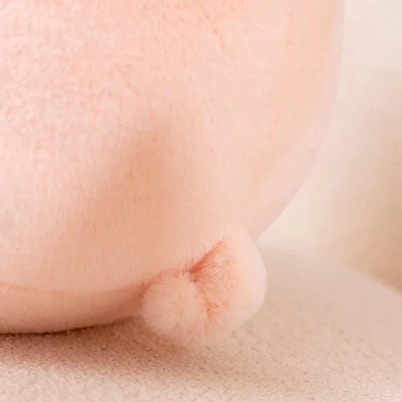 Close-up of a pink pig kawaii plush toy from behind, showing the tail