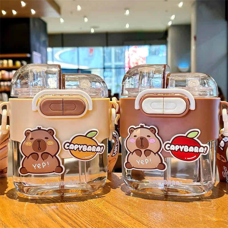 Two transparent kawaii cups with bear and apple designs on a wooden surface.