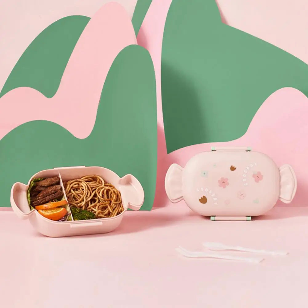 Pink kawaii bento box with food compartments and a matching pink lunch bag on a pink and green abstract background.