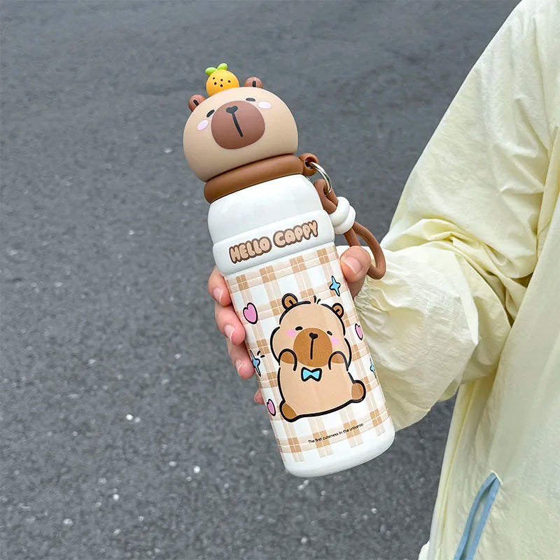 Person holding a cartoon bear-themed kawaii water bottle with a checkered design.