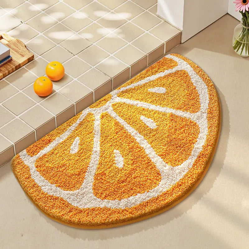 Orange-themed kawaii bath mat on a bathroom floor with tiled walls.