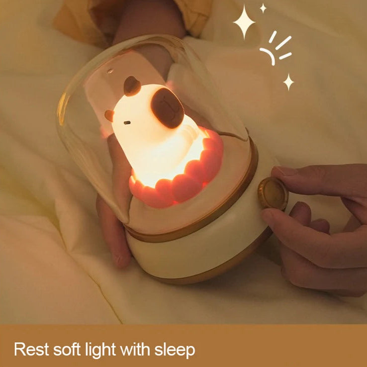 Cute kawaii animal-shaped night light being held by a person with a warm glow.