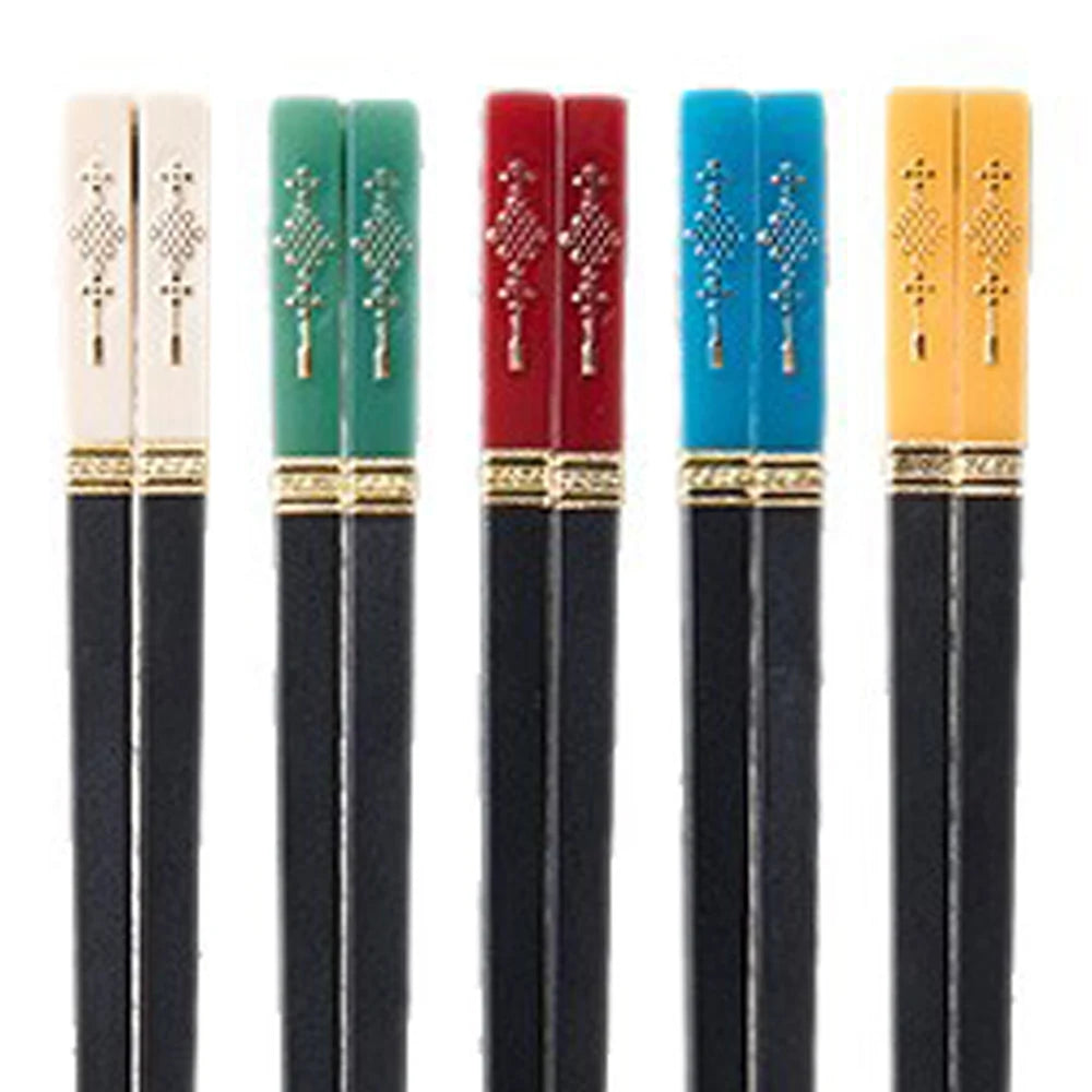 Set of black kawaii chopsticks with colorful handles on a white background