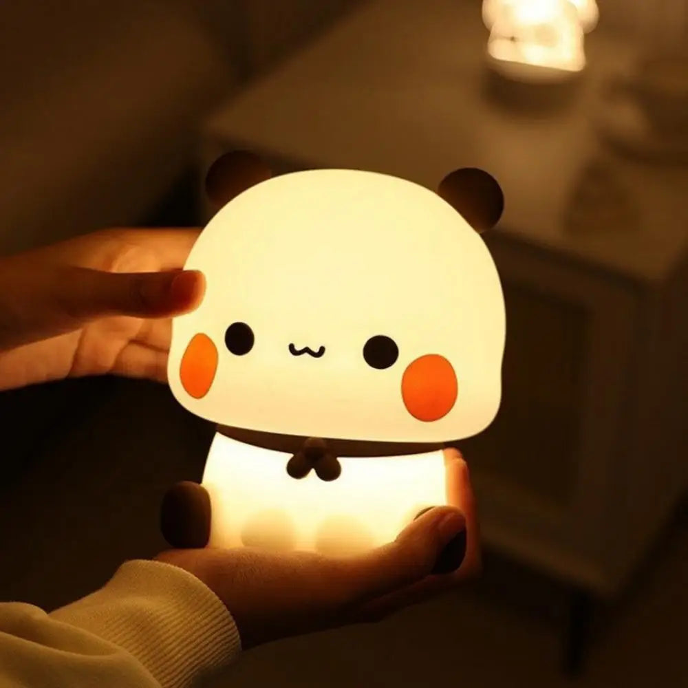 Cute panda-shaped kawaii night light held in a hand with a blurred background