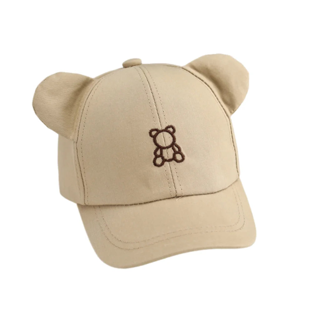 Beige cap with Kawaii bear ears and embroidered bear design on a white background