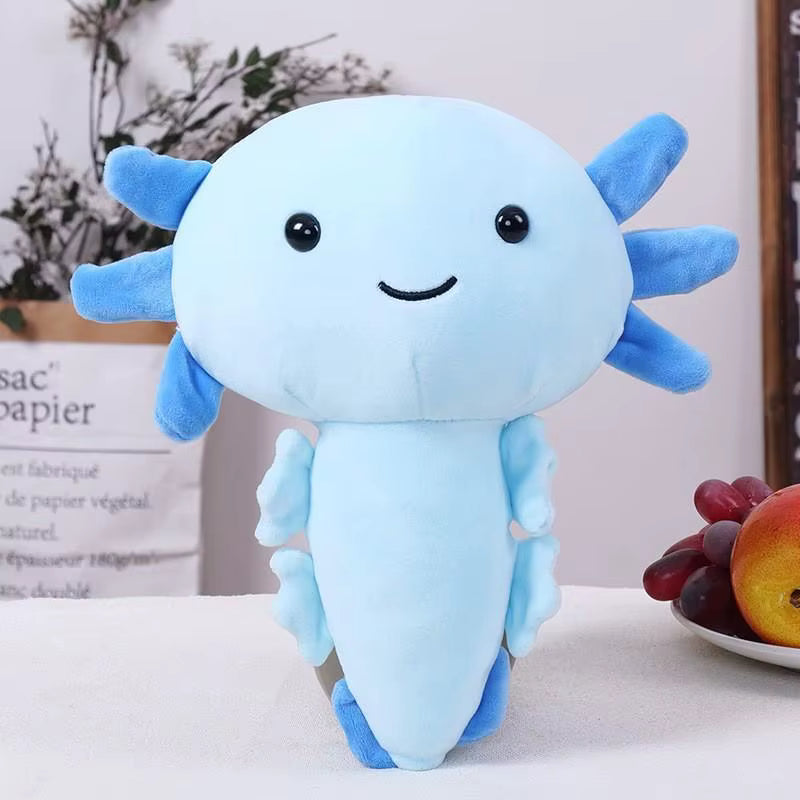 Blue axolotl plush toy on a white surface with a blurred background