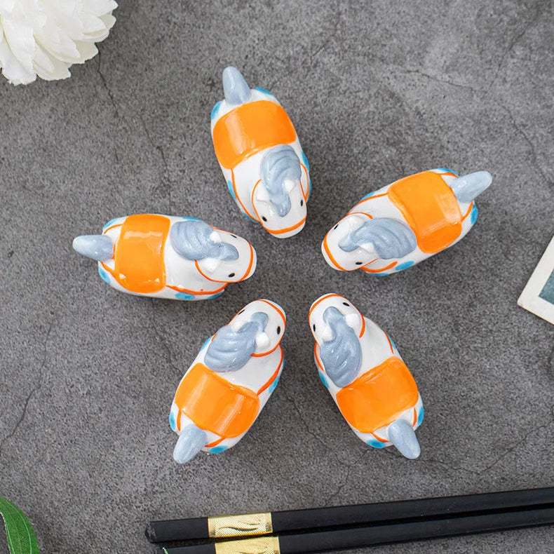 A group of horse kawaii chopstick holders on a gray surface