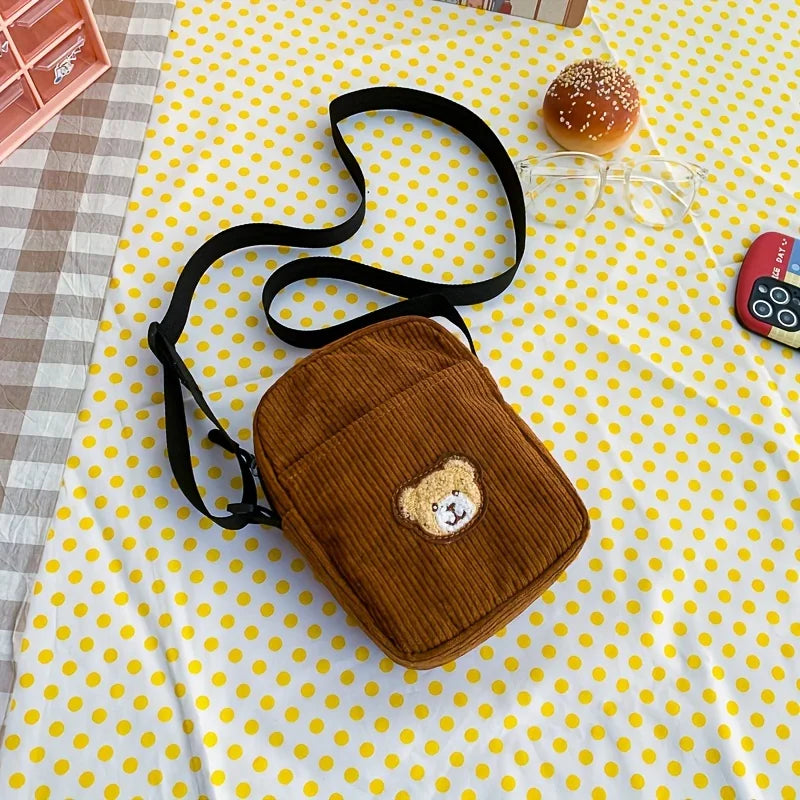Brown textured bag with a bear design on a yellow polka dot tablecloth.