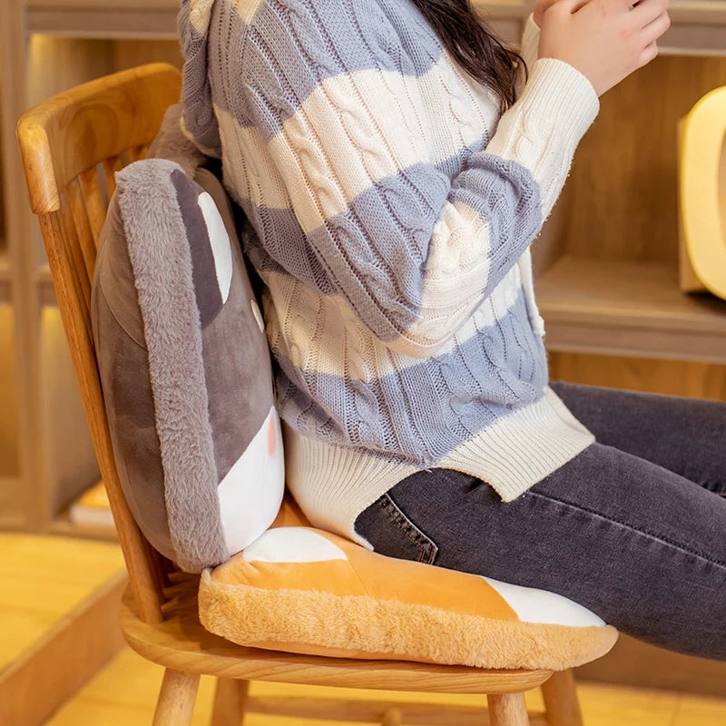 Person sitting on a wooden chair with a kawaii cushioned seat and backrest, wearing a striped sweater.