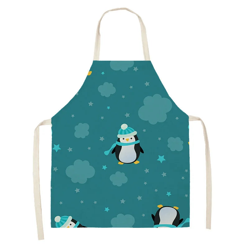 Children's Kawaii apron with penguin design on a teal background