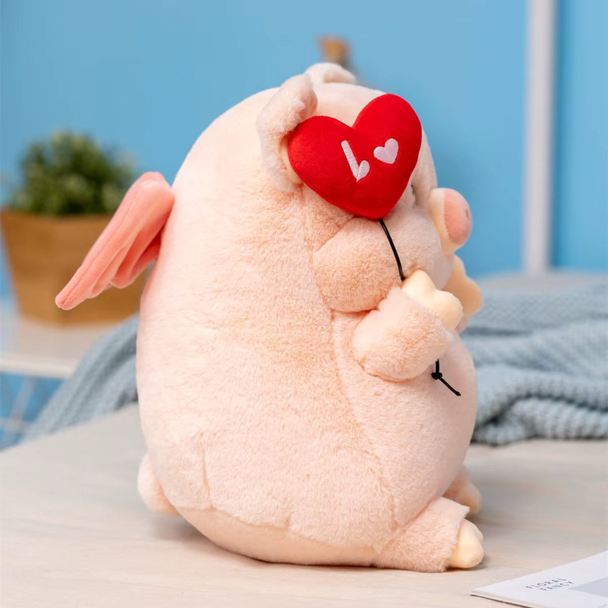 Plush toy rabbit with a red heart on a light blue background