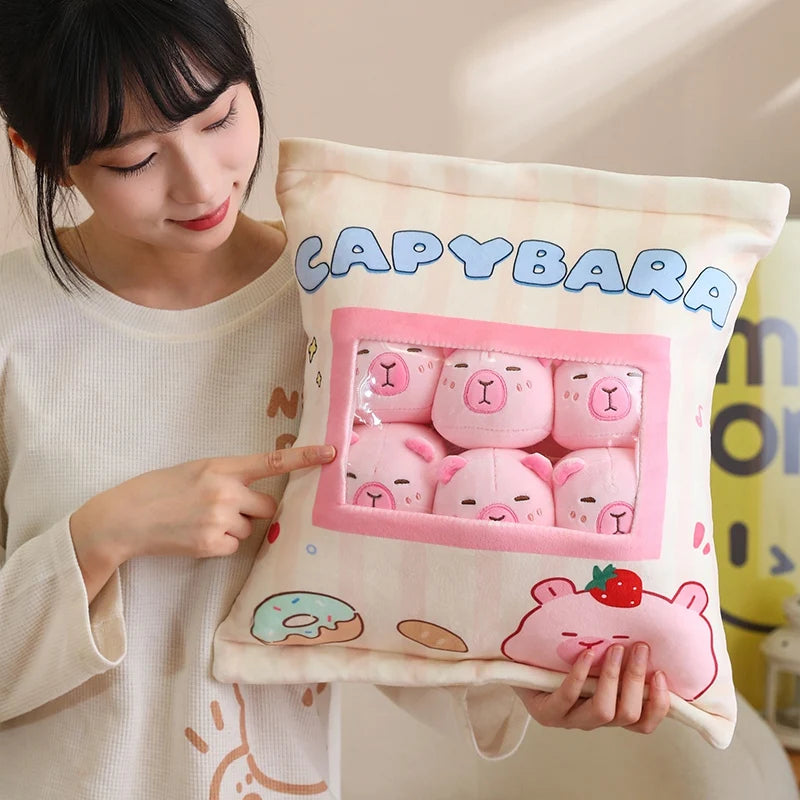 Person holding a kawaii pillow with a capybara design and text